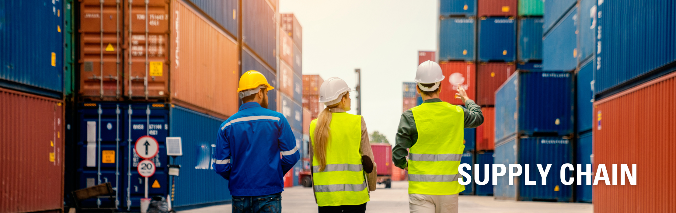 Three People Walking in a container Yard: Supply Chain.